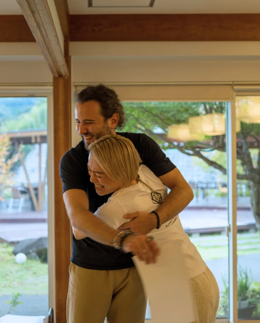 Two participants embracing in celebration during the GIVER® training in Japan