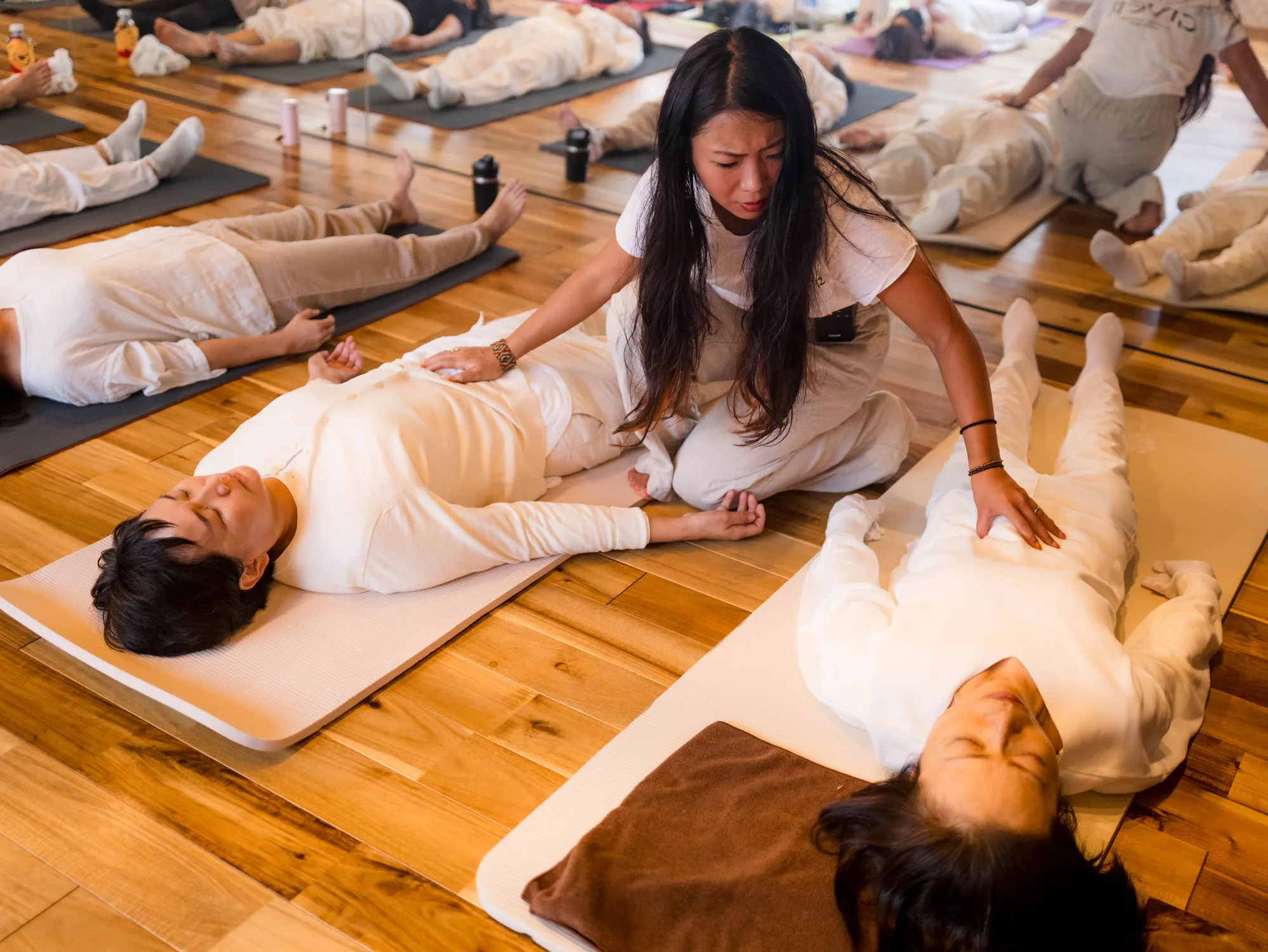 GIVER® facilitator guiding participants lying on mats in a Kundalini Activation Astral Work session