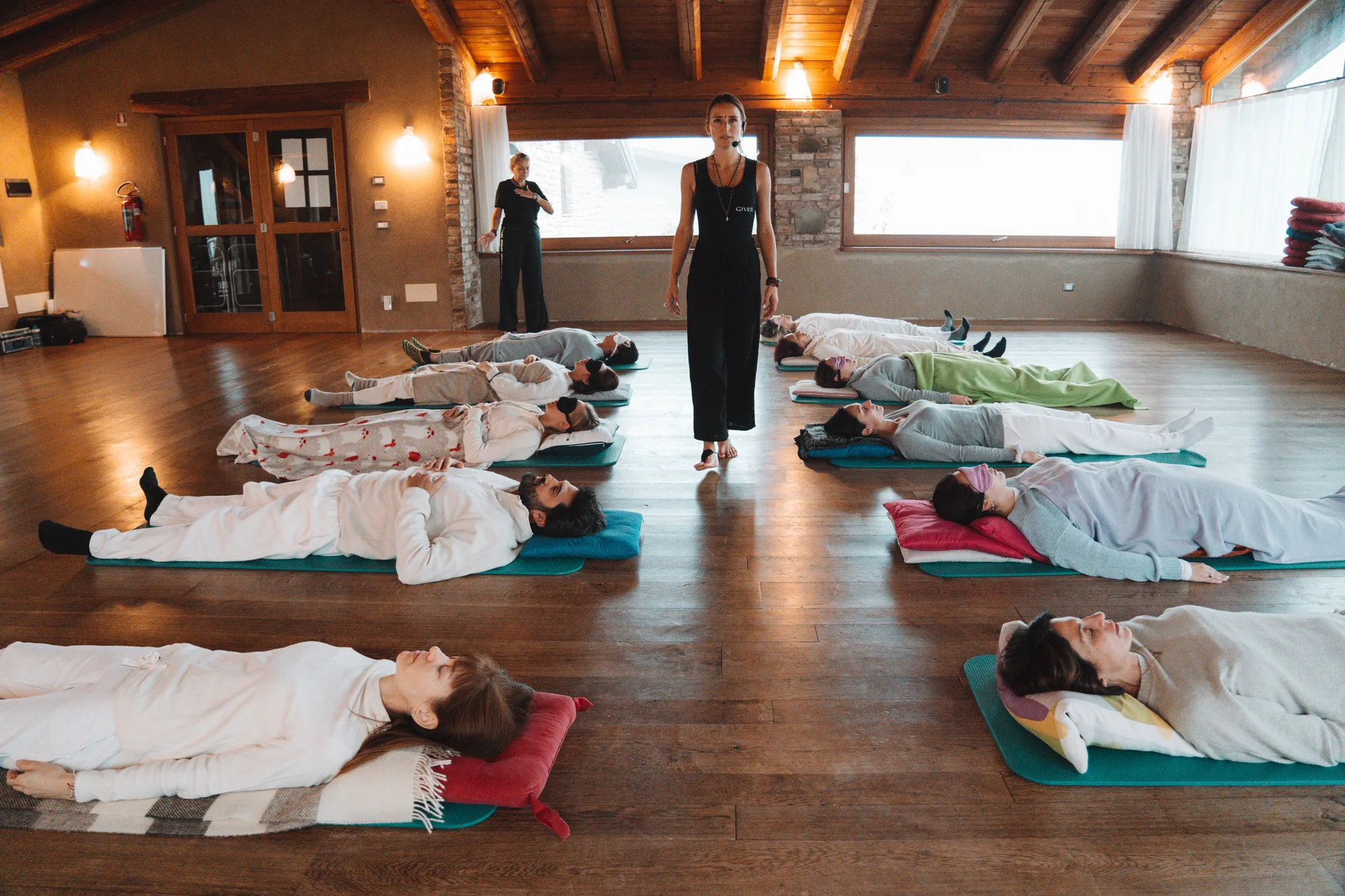 A trainee facilitator holding space during the GIVER® Kundalini Activation Astral Work training in Italy