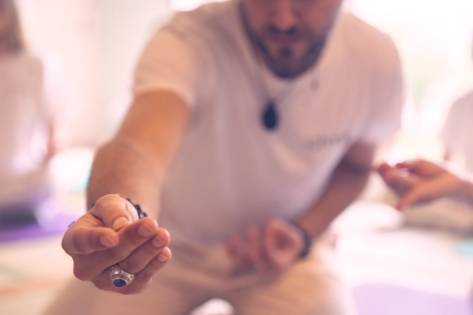 GIVER® facilitator with open hand extended during Kundalini Activation Astral Work energy transmission