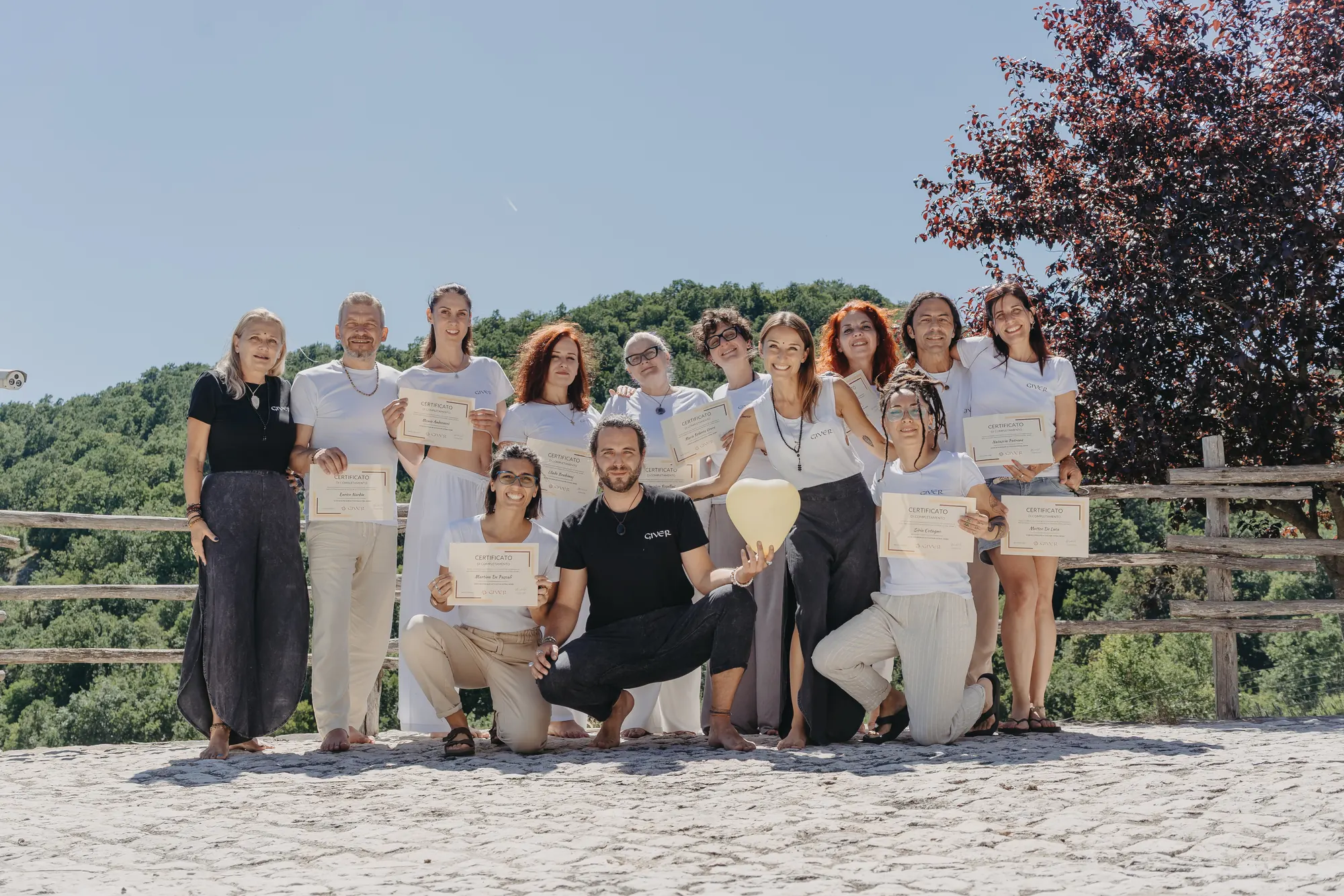 2025 GIVER® Kundalini Activation facilitator training graduates outdoors on a sunlit terrace in Italy