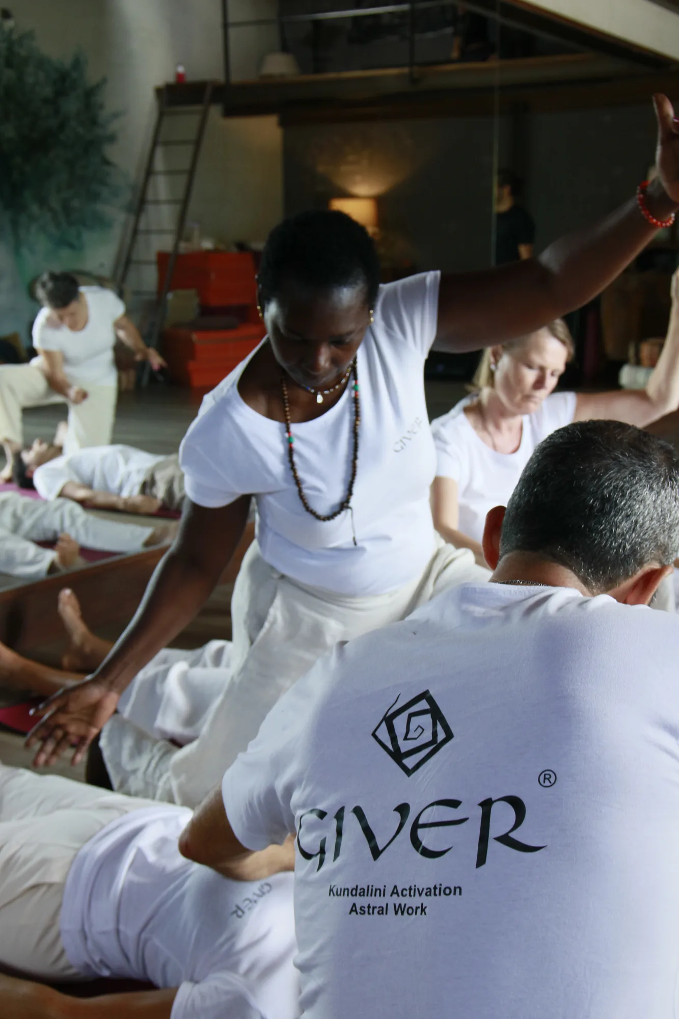 Participants in spontaneous movement during a GIVER® Kundalini Activation Astral Work session