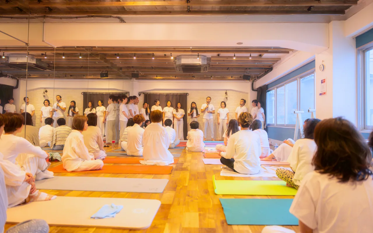GIVER® facilitators addressing a seated circle of participants before a Kundalini Activation Astral Work session in Japan