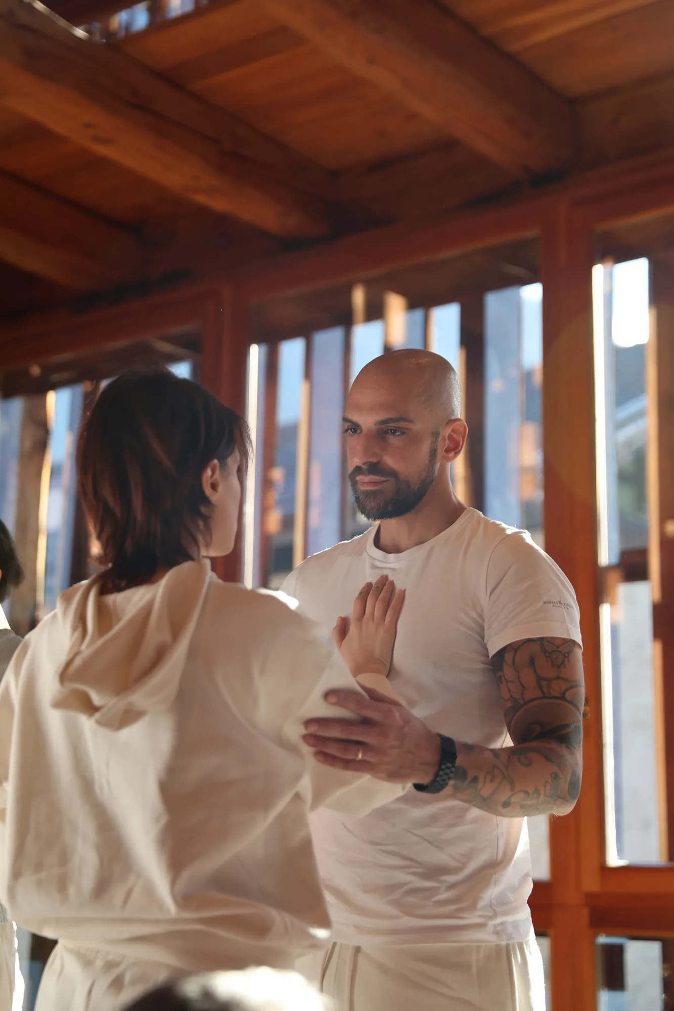 Two trainees practising energy transmission in pairs during GIVER® Kundalini Activation Astral Work facilitator training