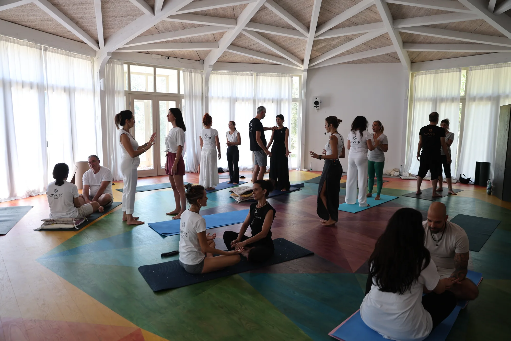 GIVER® Kundalini Activation Astral Work training group gathered in a light-filled hall in Italy