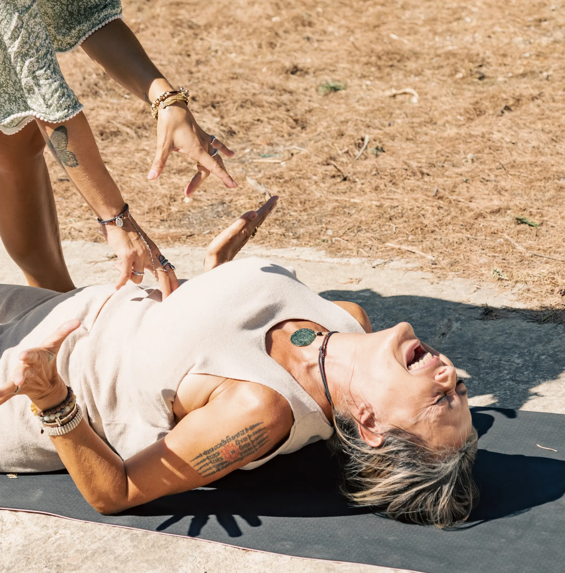 Trainee facilitator working outdoors with a participant in emotional release during GIVER® Kundalini Activation Astral Work training