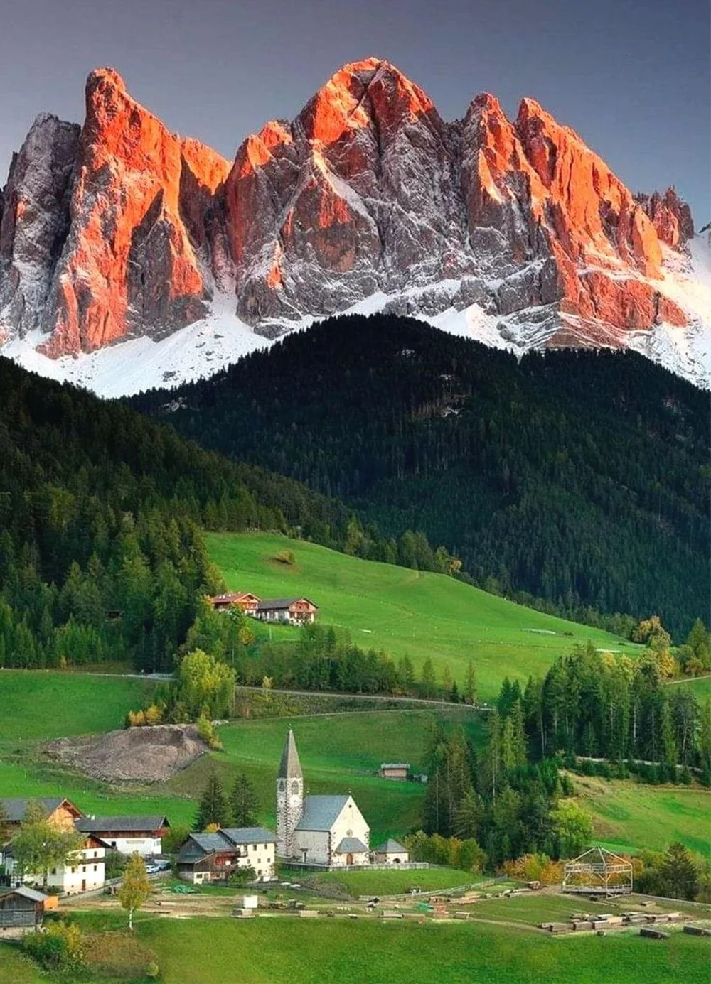 An alpine village below the Dolomites at first light — the GIVER® facilitator training in Italy