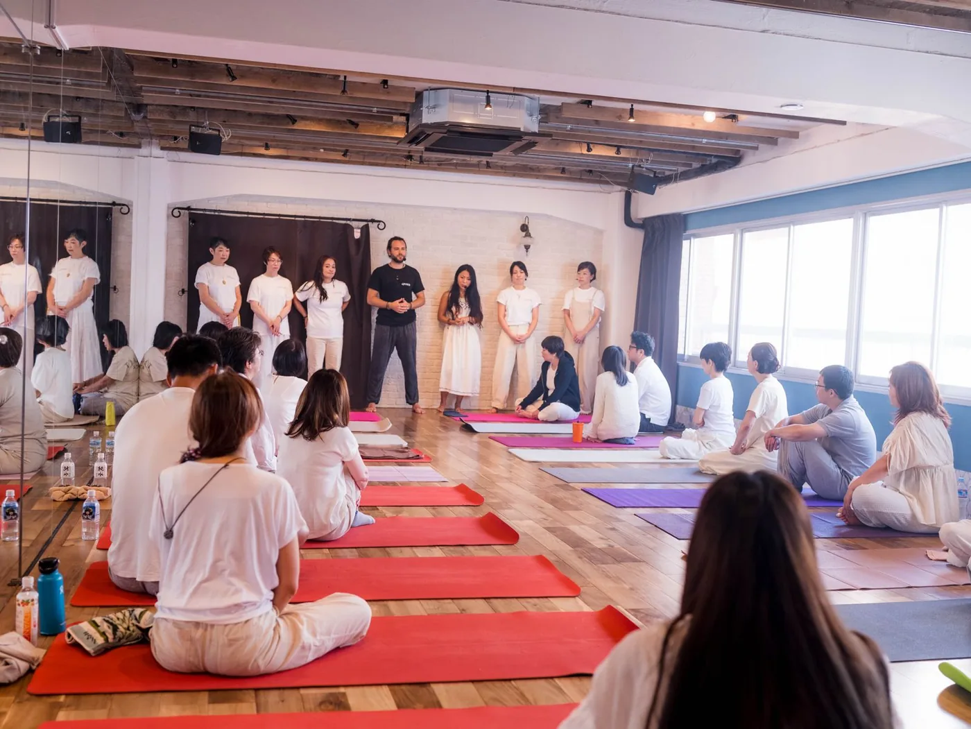 Participants seated in a Tokyo studio while the GIVER® facilitators open a Kundalini Activation Astral Work session